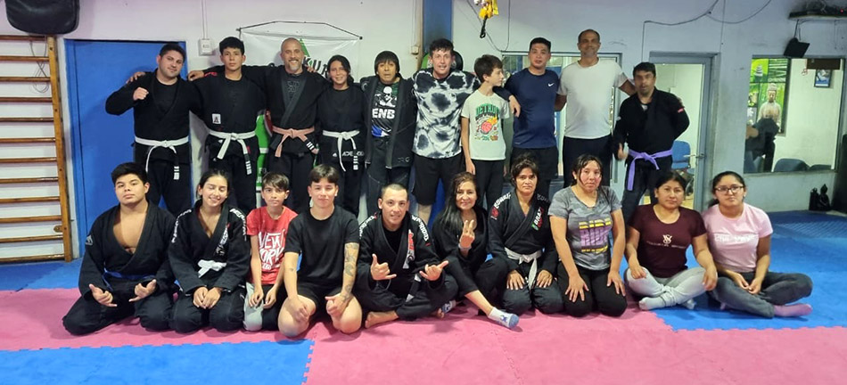 Aaron Draper (left), Granger Moffett and Jeremy Pompeo have practiced jiu-jitsu for years, earning brown, black and blue belts (respectively); Aaron Draper (back row, third from left) with the Chilean jiu-jitsu team that he, Granger Moffett and Jeremy Pompeo helped outfit.